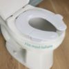 Picture of Frida Baby Fold-and-Go Potty Seat for Toilet | Foldable Travel Potty Seat for Toddler, Fits Round & Oval Toilets, Non-Slip Base, Handles, Includes Free Travel Bag