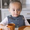Picture of Tiny Twinkle Mess Proof Baby Bib - Waterproof & Lightweight Baby-Led Weaning Apron | 100% Recycled Polyester, Easy Clean & Machine Washable (Space, Large 2-4 Years)