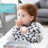 Picture of Bumkins Sleeved Bib for Girl or Boy, Baby and Toddler for 6-24 Months, Essential Must Have for Eating, Feeding, Baby Led Weaning Supplies, Long Sleeve Mess Saving Food Catcher, Hearts Black and White