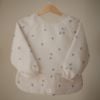 Picture of mushie Long Sleeve Baby Bib | Mess Free & Waterproof Fabric for Toddlers | Adjustable Fit for Ages 6-24 Months (Bees)
