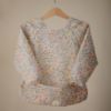 Picture of mushie Long Sleeve Baby Bib | Mess Free & Waterproof Fabric for Toddlers | Adjustable Fit for Ages 6-24 Months (Pastel Blooms)