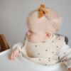 Picture of mushie Silicone Baby Bib | Adjustable Fit Waterproof Bibs (Black Daisy)