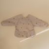 Picture of mushie Long Sleeve Baby Bib | Mess Free & Waterproof Fabric for Toddlers | Adjustable Fit for Ages 6-24 Months (Rainbows)