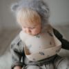 Picture of mushie Silicone Baby Bib | Adjustable Fit Waterproof Bibs (Lilac Flowers)