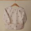 Picture of mushie Long Sleeve Baby Bib | Mess Free & Waterproof Fabric for Toddlers | Adjustable Fit for Ages 6-24 Months (Boats)