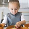 Picture of Tiny Twinkle Mess Proof Baby Bib - Waterproof Apron Machine Washable PVC, BPA, & Phthalate Free Great Travel for Eating Food Bibs (Charcoal, Small 6-24 Months) 3 ounces