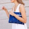 Picture of Bumkins Waterproof Wet Dry Clutch Bag for Baby, Travel, Swim Suit, Cloth Diapers, Pump Parts, Pool, Gym Clothes, Toiletry, Hook to Stroller, Pack for Daycare, Zip Bag, Packing Pouch, Evil Eye