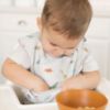 Picture of Tiny Twinkle Mess-Proof Baby Bib - Waterproof Bib for Baby Boy or Girl - Machine Washable - Adjustable Closure - PVC, BPA, & Phthalate Free - Great for Travel - Baby Food Bibs (3 Pack, Sea, Dino)