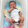 Picture of Happiest Baby SNOO Sleep Sack - 100% Organic Cotton Baby Swaddle Blanket - Doctor Designed Promotes Healthy Hip Development (Tie Dye Rainbow, X-Large)