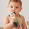 Picture of Itzy Ritzy Spinner Rattle Toy - Cow Design Sensory Teething Rattle Includes Spinning Face, Clicks, Rattles & Textured Teethers - Designed for Ages 3 Months and Up (Cow)
